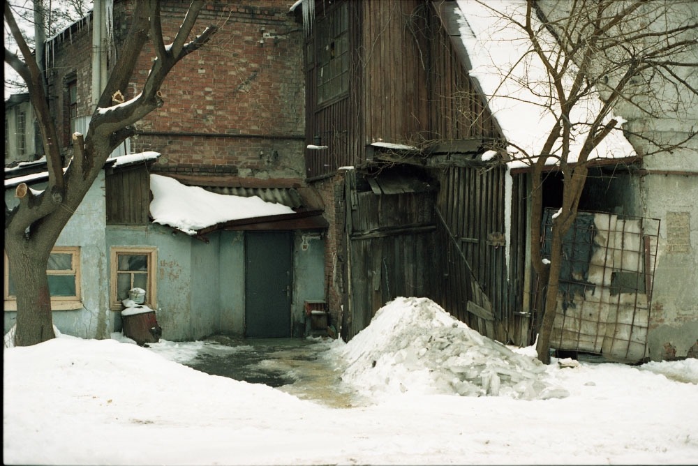 A photo of Kharkiv. It looks cold, and the buildings are mostly made of bare metal and red brick.