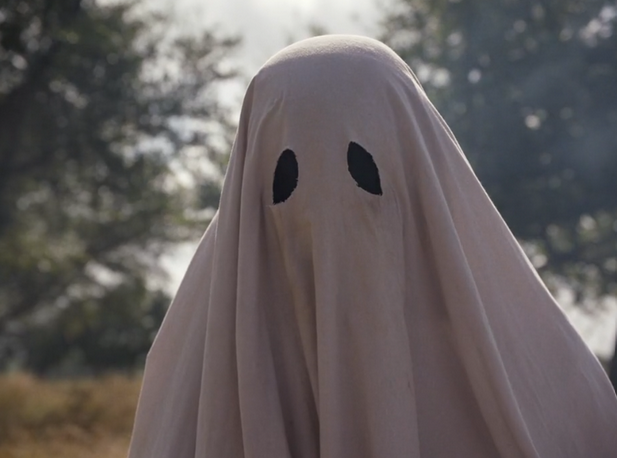 A close up of a traditional, sheets-style halloween ghost.